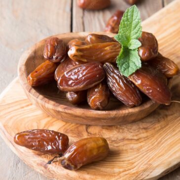 Premium Photo _ Dates palm fruit in wooden bowl is snack healthy_